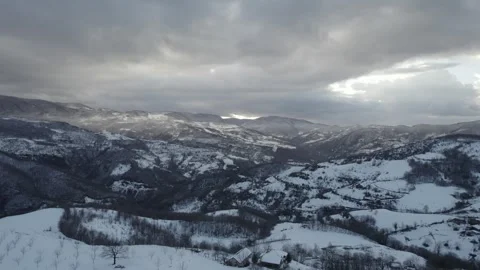Aerial view of a winding road through a snowy forest. Stock Footage 310028388