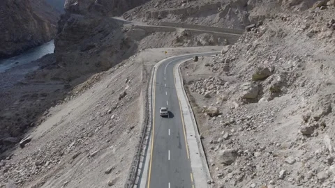 Aerial view of a winding road through the mountainous terrain of Pakistan, with 스톡 동영상 314455840