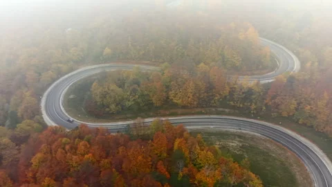 An aerial view of the winding road through a high mountain pass Stock Footage 329864943