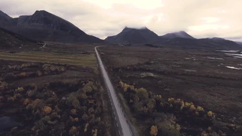 Aerial view of winding road through mountainous landscape Stock Footage 330164641