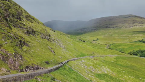Aerial View Of Winding Road Through Lush Green Irish Mountains In County Mayo Video stock 345088522