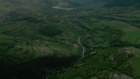 Aerial view winding road through green valley hills Stock-Footage 345166077