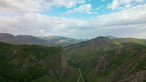 Aerial view winding road through green valley hills Stock-Footage 345166137