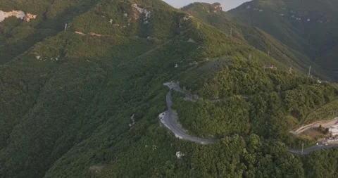 Aerial view of winding road through mountains at sunset, Italy. Stock Footage 345223336