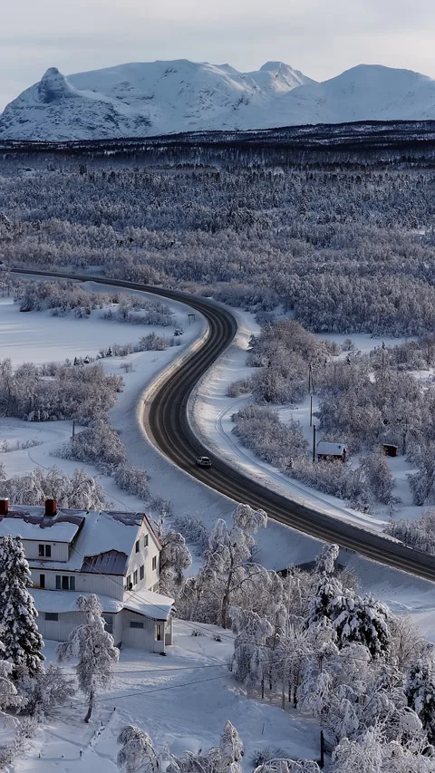 Aerial view of winding road through snowy forest and mountains, Norway Stock-Footage 345969081