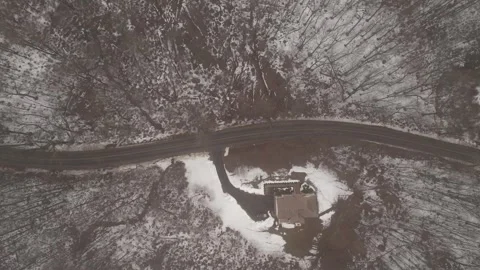 Aerial view of a winding road through a snow covered Stock Footage 346298616
