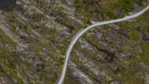 Aerial view of winding road through moss-covered rocky terrain, Rauma Norway Stock-Fotos