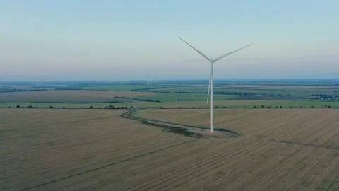 Aerial view of a windmill in agricultural fields generating renewable energy. Stock Footage 158257022