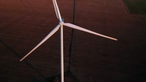 Aerial view of a windmill with farm fields in the background at sunset. Stock-Footage 169412123
