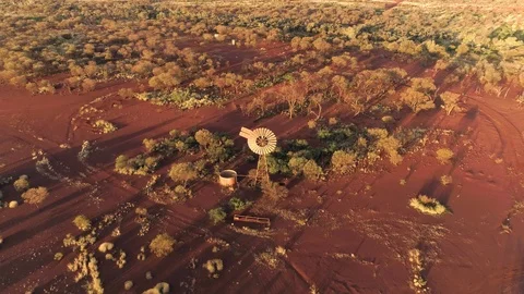 Aerial view of windmill in red desert Stock Footage 89057510