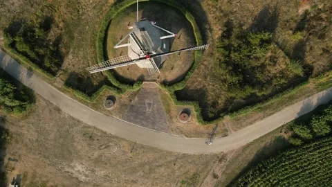 Aerial view of windmill with rotating blades in scenic landscape Stock Footage 293158346