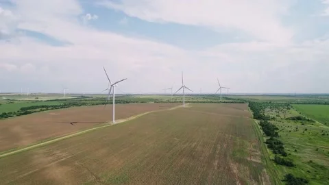 Aerial view of windmills farm in the fields. World energy power crisis. Green Stock Footage 207727487