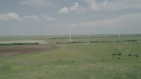 Aerial view of windmills farm in the fields. World energy power crisis. Green Stock Footage 223530200