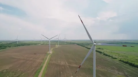 Aerial view of windmills farm in the fields. World energy power crisis. Green Stock Footage 223530594