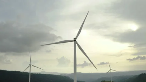 Aerial view, windmills rotating on cloudy sky at highland. Drone shot Stock Footage 203478783