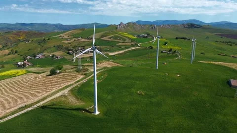 Aerial view of windmills turning, wind power turbines generate Stock Footage 310119663