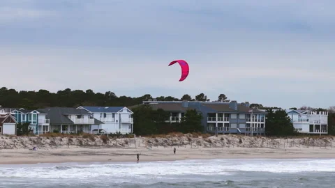 Aerial view of a Windsurfer preparing the kite for a ride at a beach, cloudy day Stock-Footage 327629704
