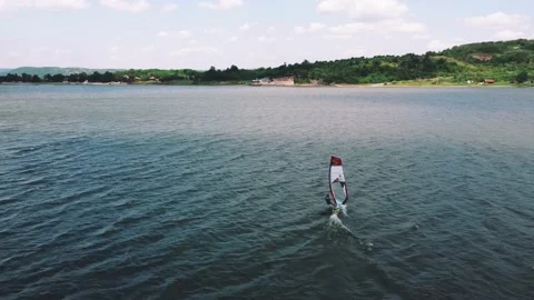Aerial View Of Windsurfing Gliding Across Lake Extreme Sport Stock Footage 157565239
