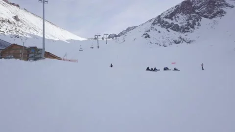 Aerial View. Winter Alpine Ski Resort. Skiers, ski lift and snow mountains Stock Footage 144047968