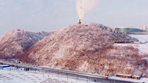 Aerial view of Winter hilly city with roads, trees, monument and buildings Stock Footage 144942753
