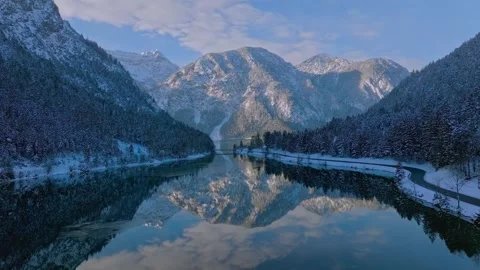 Aerial view of winter lake reflection with snowy alpine mountains Stock Footage 339781316