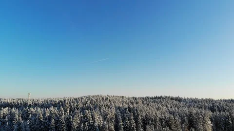 Aerial view of winter landscape with blue sky captured from above with a drone Stock Footage 101735873