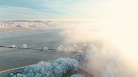 Aerial View Of Winter Landscape During Sunrise and Think Clouds Stock Footage 325303320
