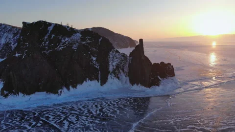 Aerial view of winter landscape of high mountain on frozen lake. Cape Khoboy Stock Footage 110985779
