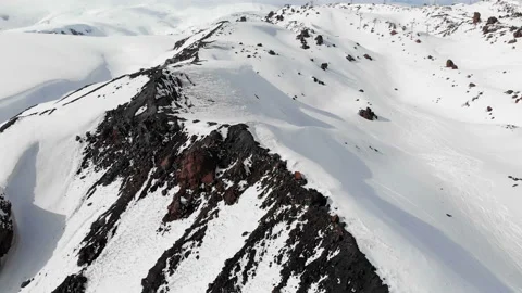 Aerial view of a winter mountain landscape. The snow-covered rocky slopes of the Stock Footage 112276740