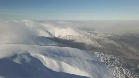 Aerial view of the winter mountain range on a sunny day. Snow-capped mountain Stock Footage 148300463