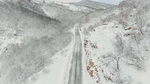 Aerial view of winter mountain road covered with snow, driving car and truck. Stock Footage 101466003