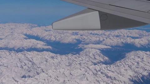 Aerial view of winter mountains from window of airplane Stock Footage 79008931