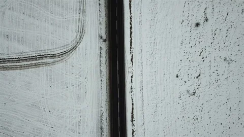 Aerial view of the winter road on the background of snow-covered fields Stock Footage 99385798