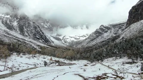 Aerial view of winter snow covered canyon bare rock layered peak ridge in Aba Video stock 337926397