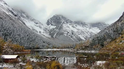 Aerial view of winter snow mountain valley village stream white snow mountain Stock Footage 337926560