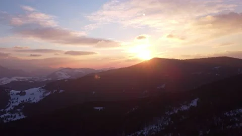Aerial view of winter sunset over alpine silhouette mountains, Stock-Footage 171991180