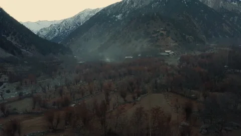 Aerial view of winter trees in the mountains of Kalash valley,Pakistan Stock Footage 170591235
