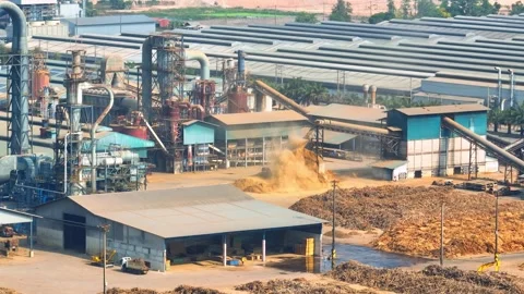Aerial view of a wood processing factory featuring timber stockpiles. Stock-Footage 332826213