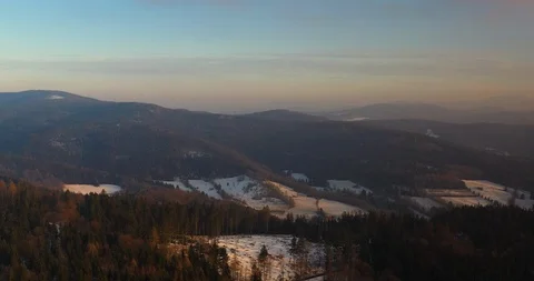 Aerial view of woods and mountains in winter Stock Footage 123740449