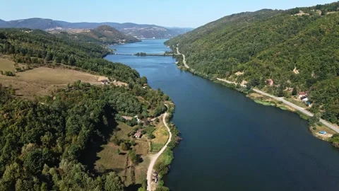 Aerial view of woods and small houses on a hillside surrounding Danube river Stock Footage 263142807