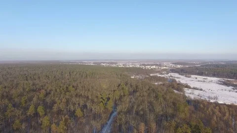 Aerial view of woods, fields and the frozen river in winter Stock Footage 71443918