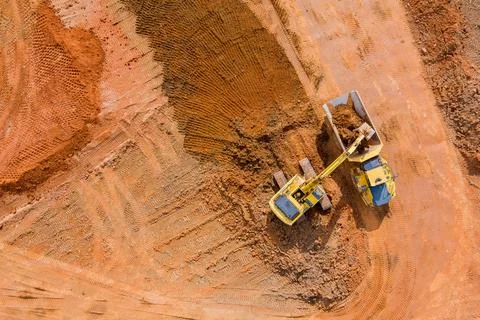 Aerial view work on construction site of bulldozer is scraping a layer of soi Stock Photos