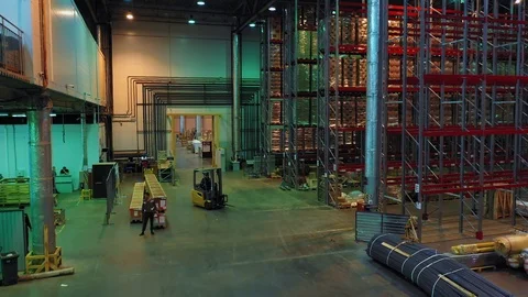 Aerial view of a work in a spacious mail warehouse a loader moves the parcel Stock Footage 113091175
