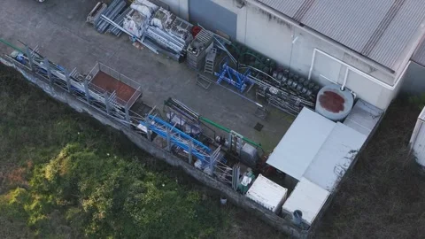 Aerial view of a worker cleaning the backyard of a warehouse 動画素材 346373591