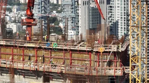 Aerial view of workers and cranes at a construction site Stock Footage 228111832