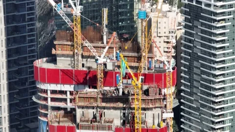 Aerial view of workers and cranes at a construction site Stock Footage 228116818
