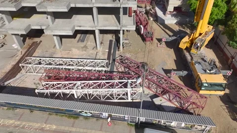 Aerial View: Workers and engineers work together to install a towering crane Video stock 296019520