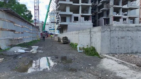 Aerial View: Workers and engineers pour concrete on a large construction site Stock Footage 296070531