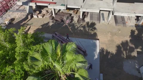 Aerial View: Workers and engineers coordinate to install a giant crane, creating 動画素材 296100506