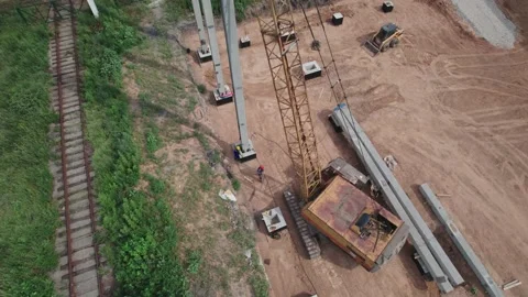 Aerial view. Workers are using a large crane to install concrete posts Stock Footage 156443304